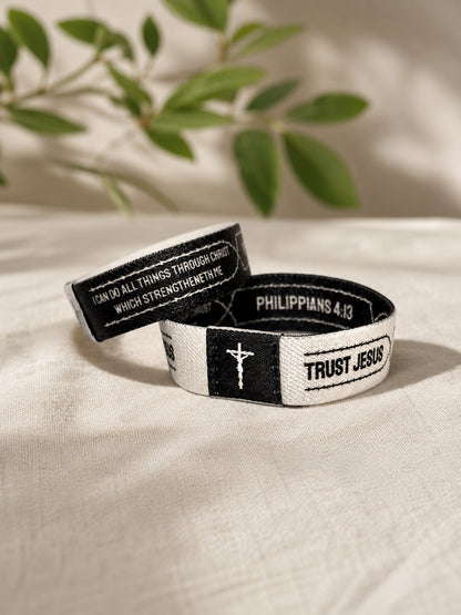 White and black Trust Jesus Christian wristband featuring Philippians 4:13